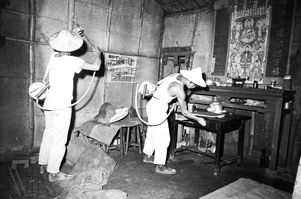 圖4 防瘧工作人員背著內裝DDT殺蟲劑的壓縮式噴霧器，於民宅內進行噴灑作業
